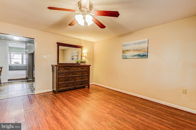 spare room featuring ceiling fan and hardwood / wood-style floors