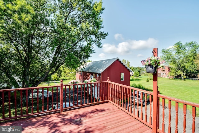 wooden terrace featuring a yard