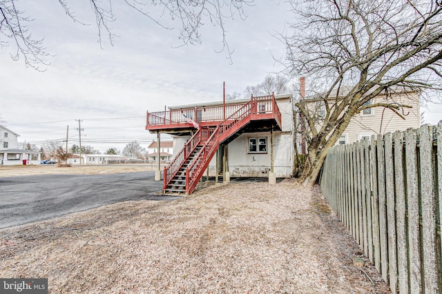 back of house featuring a wooden deck