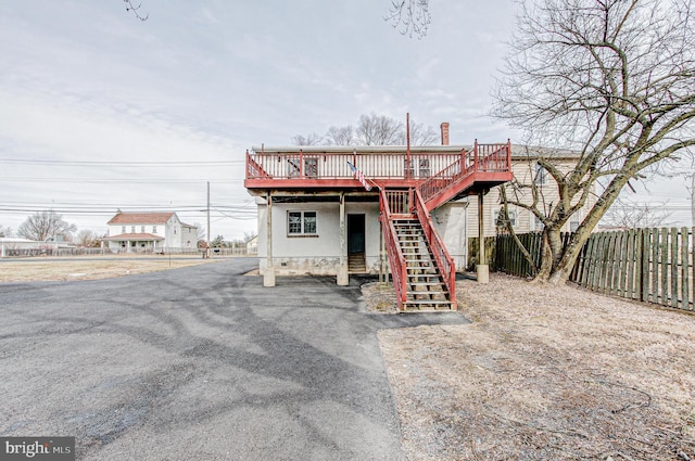 back of house with a deck