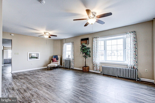 unfurnished room featuring ceiling fan, wood-type flooring, and radiator