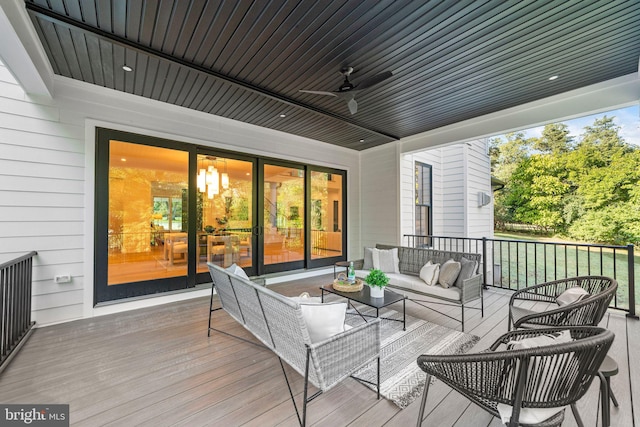 deck featuring ceiling fan and an outdoor living space