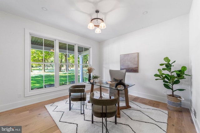 living area featuring a chandelier and light hardwood / wood-style flooring