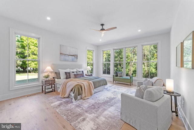 bedroom with light hardwood / wood-style flooring and ceiling fan