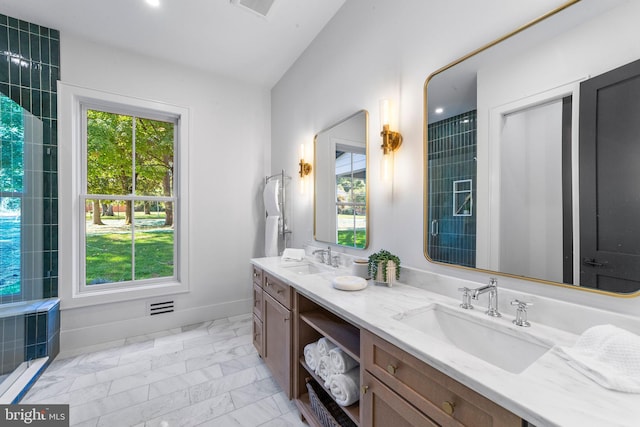 bathroom featuring vanity and lofted ceiling