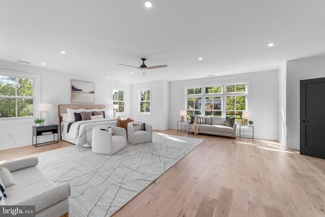 bedroom with light hardwood / wood-style flooring and ceiling fan