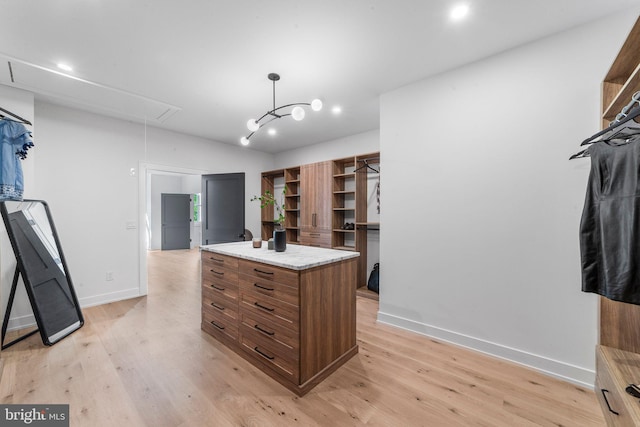 walk in closet with lofted ceiling and light wood-type flooring