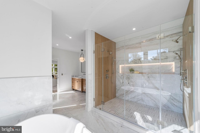 bathroom with walk in shower and vanity