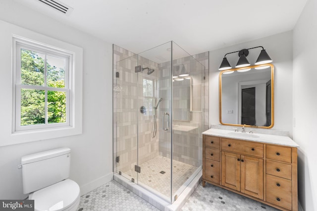 bathroom featuring vanity, tile patterned floors, toilet, and walk in shower