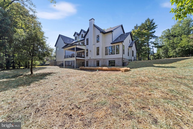 back of house with a lawn