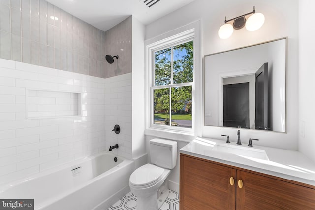 full bathroom featuring vanity, toilet, and tiled shower / bath combo