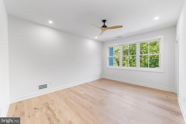 empty room featuring ceiling fan and light hardwood / wood-style floors