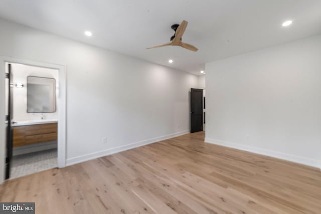 empty room featuring ceiling fan and light wood-type flooring