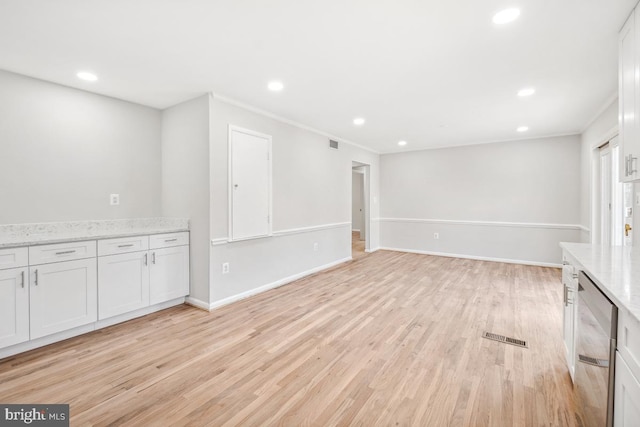 interior space featuring light hardwood / wood-style flooring and crown molding