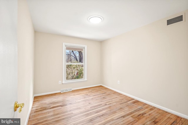 spare room with light hardwood / wood-style floors