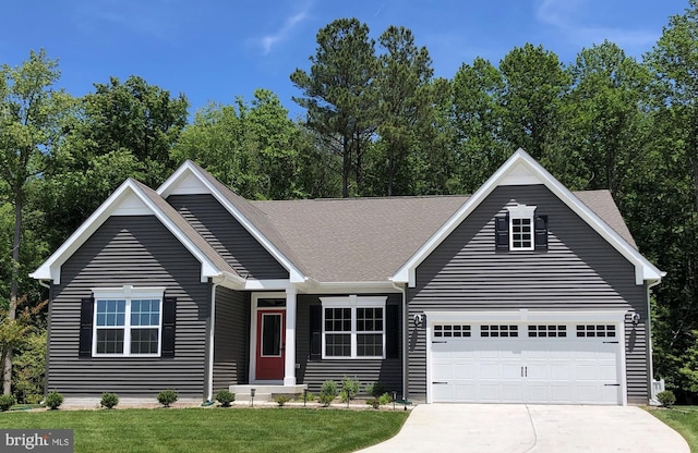 view of front of property with a garage and a front yard