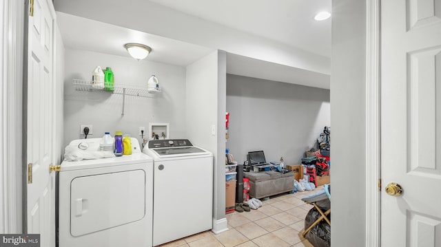 laundry area featuring washing machine and dryer and light tile patterned floors