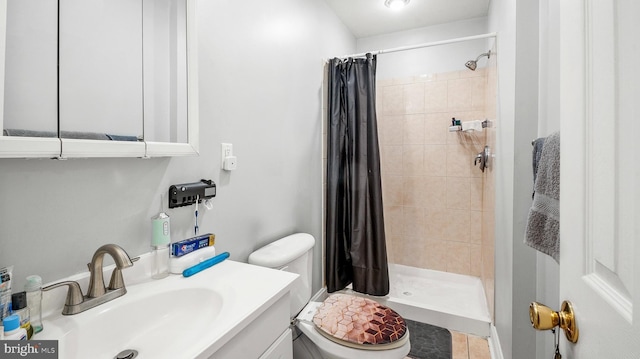 bathroom with walk in shower, vanity, and toilet