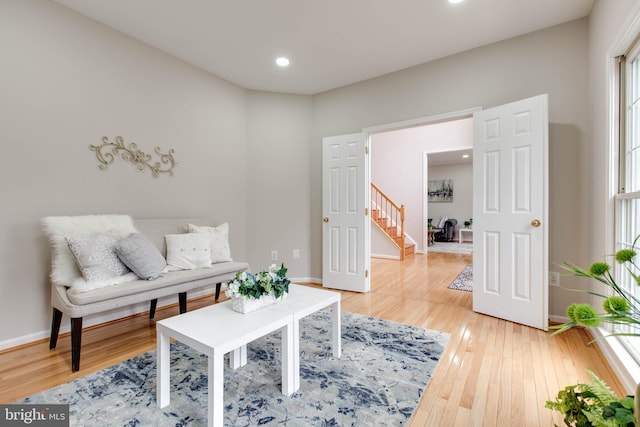 living room with recessed lighting, baseboards, and light wood-style floors