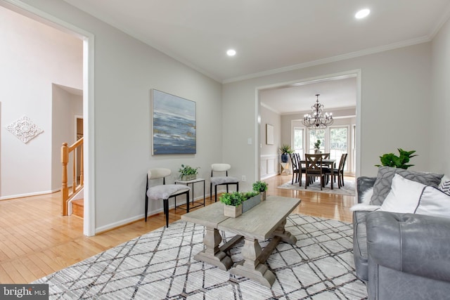 living area with baseboards, light wood-type flooring, stairs, ornamental molding, and recessed lighting