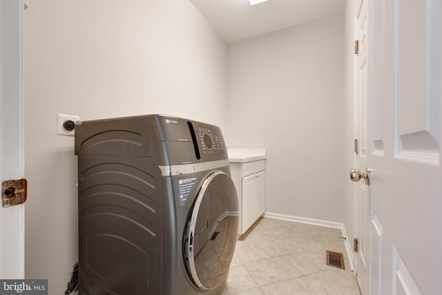 laundry area featuring visible vents, cabinet space, washer / clothes dryer, and baseboards