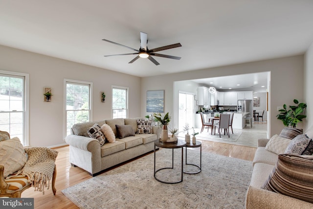 living area featuring recessed lighting, a ceiling fan, and light wood finished floors