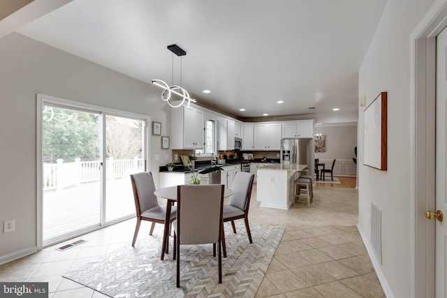 dining area featuring visible vents, baseboards, light tile patterned floors, recessed lighting, and a notable chandelier