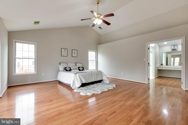 unfurnished bedroom with visible vents, lofted ceiling, baseboards, and light wood-style flooring