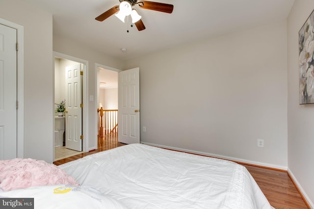 bedroom featuring ceiling fan, baseboards, and wood finished floors