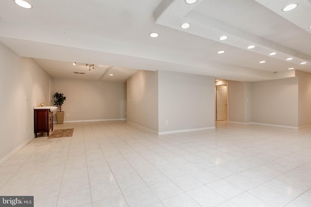 empty room with light tile patterned floors, recessed lighting, and baseboards