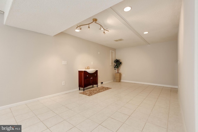 spare room featuring visible vents, baseboards, light tile patterned floors, recessed lighting, and a textured ceiling