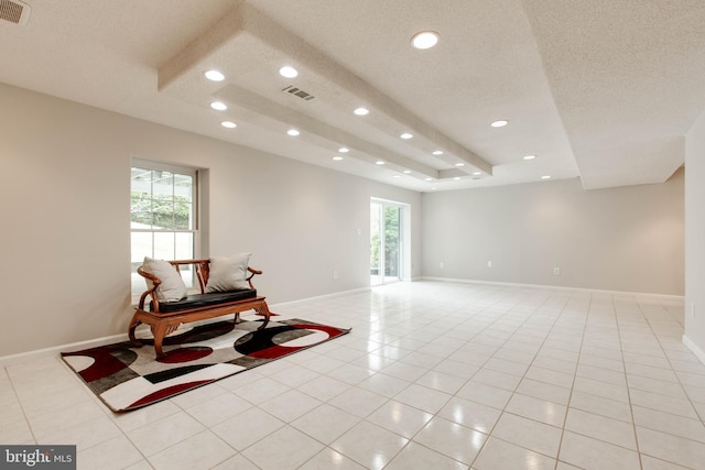 living area with light tile patterned floors, recessed lighting, visible vents, and a textured ceiling