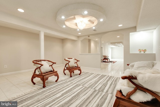 living area featuring light tile patterned flooring, recessed lighting, and baseboards