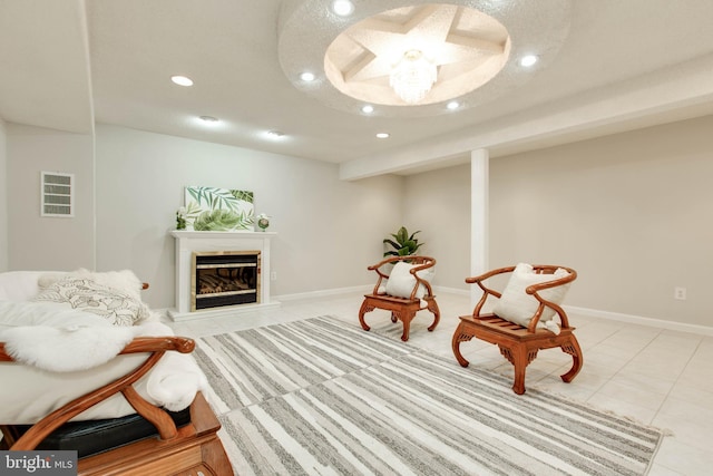 sitting room with visible vents, a glass covered fireplace, recessed lighting, light tile patterned floors, and baseboards