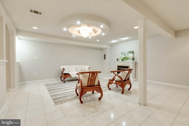 sitting room with light tile patterned floors, visible vents, baseboards, recessed lighting, and a fireplace