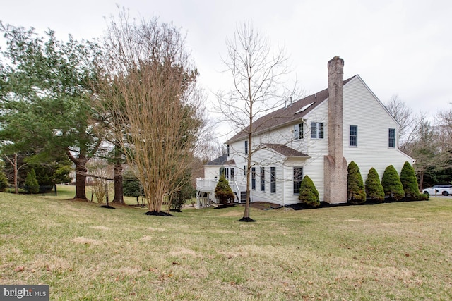 view of property exterior with a lawn and a chimney