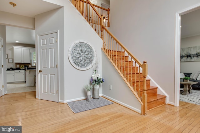 stairway with baseboards and wood-type flooring