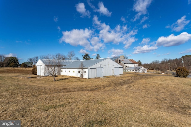 exterior space featuring an outbuilding and a lawn