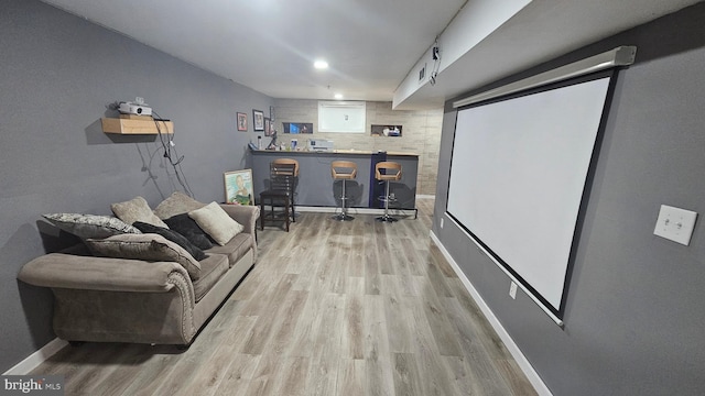 living room with light hardwood / wood-style flooring and indoor bar