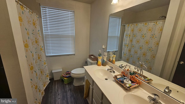 bathroom featuring hardwood / wood-style floors, toilet, curtained shower, and vanity