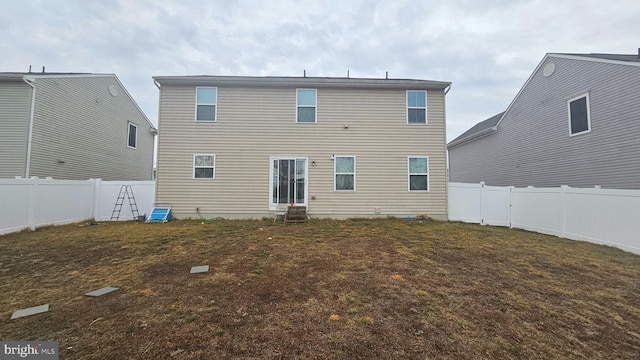 rear view of property with a yard