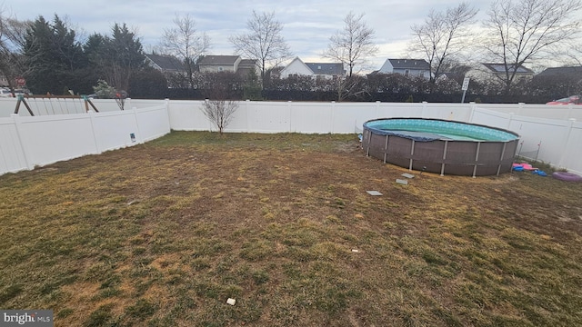 view of yard featuring a fenced in pool