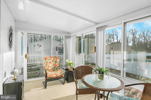 sunroom featuring vaulted ceiling