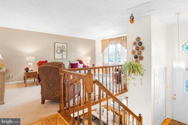 stairs featuring a textured ceiling