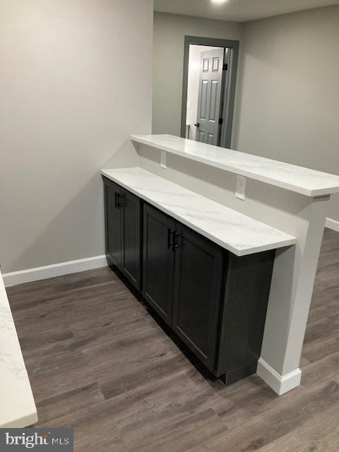 bar with dark wood-style floors and baseboards