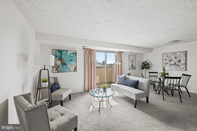 carpeted living room featuring a textured ceiling