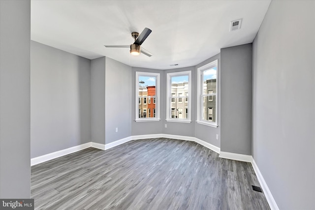 spare room featuring wood-type flooring and ceiling fan