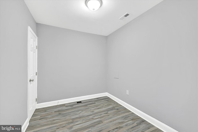 spare room with dark hardwood / wood-style floors