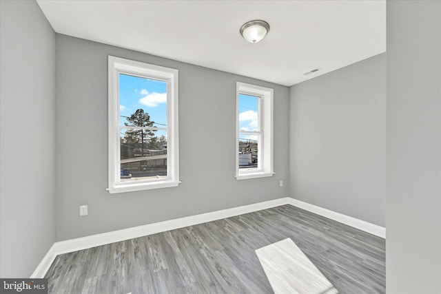 spare room with hardwood / wood-style flooring