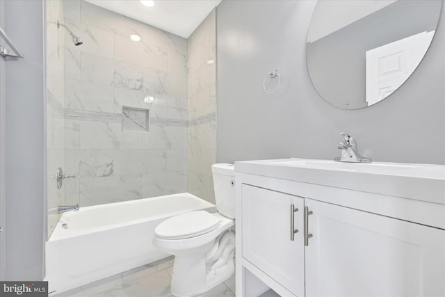 full bathroom featuring tiled shower / bath combo, vanity, and toilet